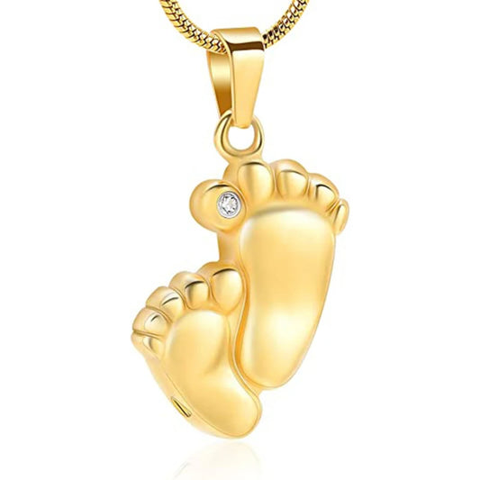 Gold baby footprints pendant with a diamond on a white background