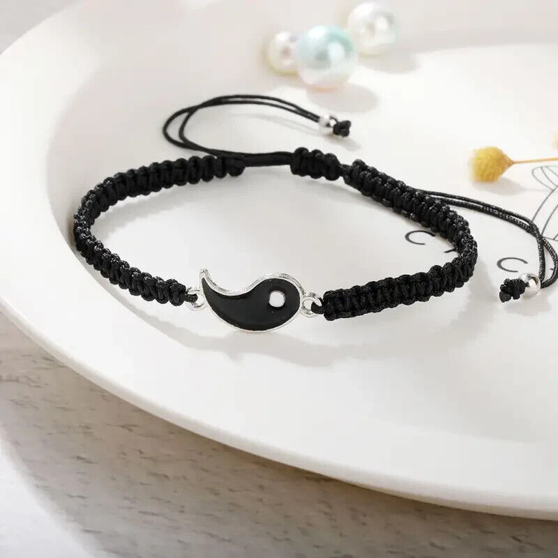 Close-up of the white bracelet from the Best Friend Couple Matching Yin Yang Adjustable Cord Bracelets, featuring a half yin yang charm on an adjustable cord.
